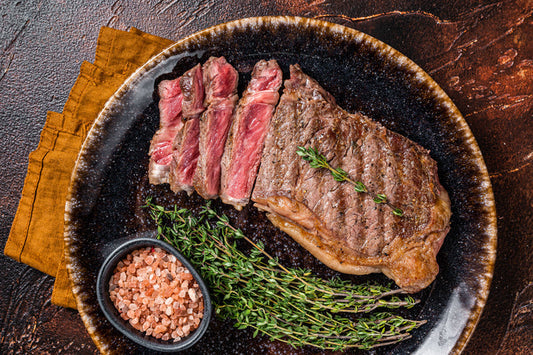 Sliced grass-fed New York strip steak on a plate