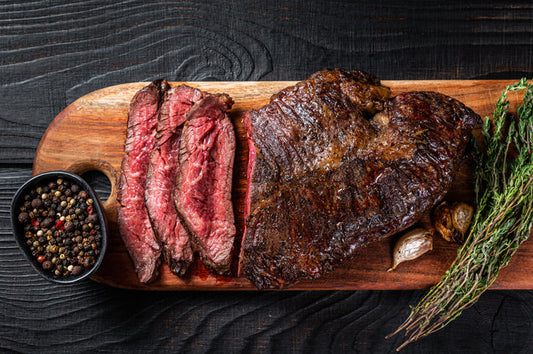 Grilled Texas grass fed hanger steak on a wooden cutting board