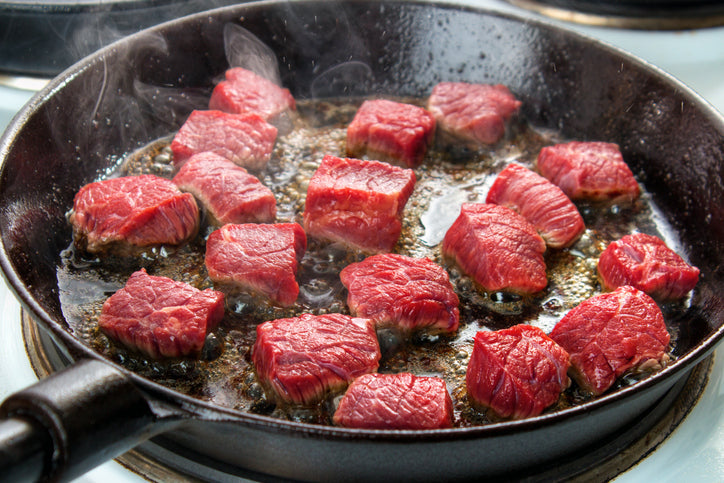 Grass fed beef searing in skillet